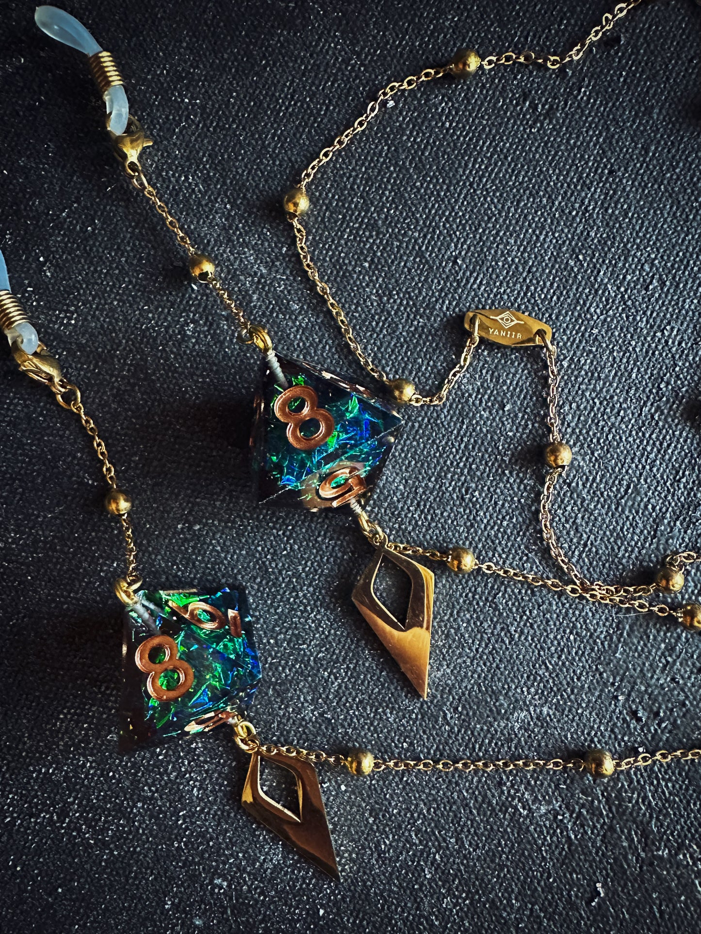 gold glasses chain with black d8 dice charms