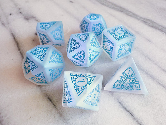 Frosted rainbow glass dice with an elven design in blue